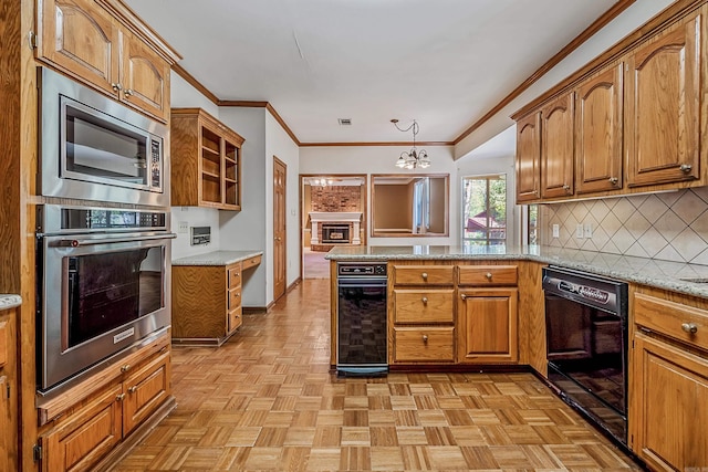 kitchen with pendant lighting, backsplash, stainless steel appliances, light stone countertops, and light parquet flooring