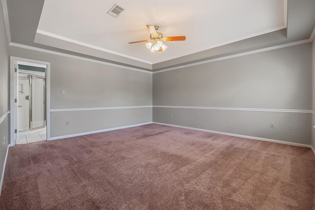 unfurnished room with a raised ceiling, crown molding, light colored carpet, and ceiling fan