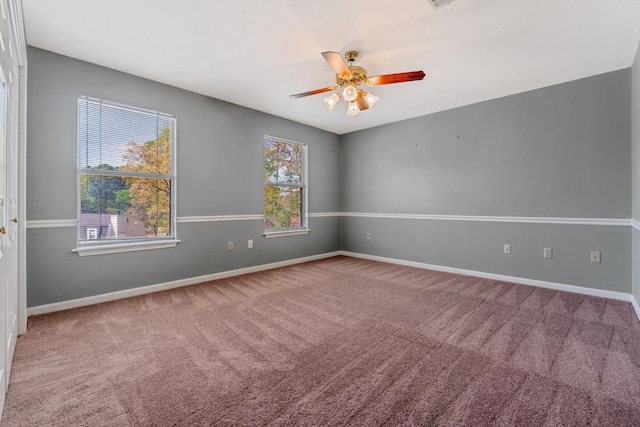 carpeted empty room with plenty of natural light and ceiling fan