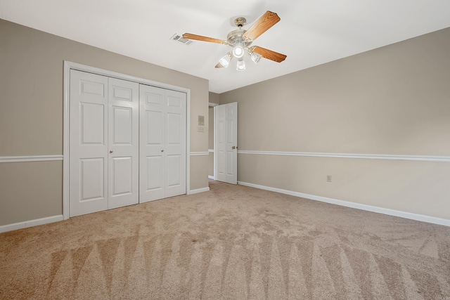 unfurnished bedroom featuring a closet, ceiling fan, and carpet flooring