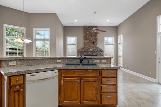 kitchen with white dishwasher, sink, pendant lighting, and plenty of natural light