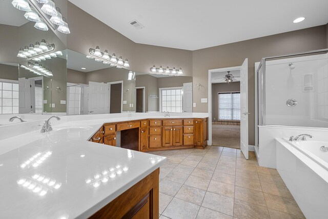 bathroom featuring vanity, tile patterned floors, ceiling fan, and a tub to relax in