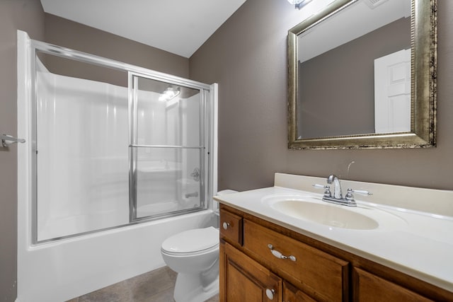 full bathroom featuring enclosed tub / shower combo, vanity, toilet, and tile patterned flooring