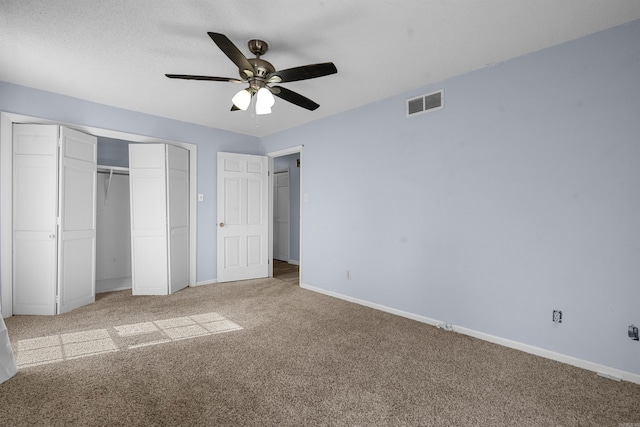 unfurnished bedroom featuring light colored carpet and ceiling fan