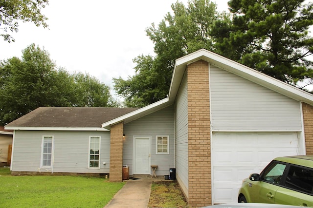 exterior space with a garage and a front lawn