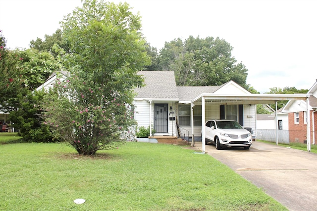 view of front of property with a front yard and a carport