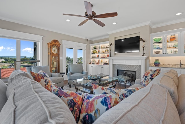 living room with crown molding, ceiling fan, and french doors