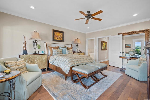 bedroom featuring hardwood / wood-style flooring, ornamental molding, and ceiling fan