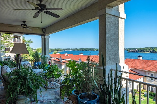 view of patio with a balcony, a water view, and ceiling fan