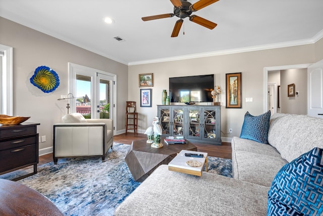 living room featuring hardwood / wood-style flooring, ceiling fan, and crown molding