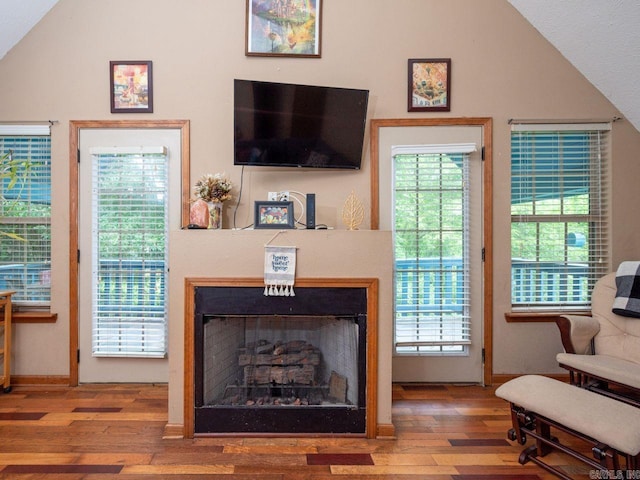 living room with wood-type flooring and vaulted ceiling