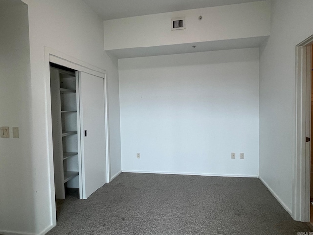 unfurnished bedroom featuring dark carpet