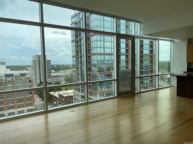 interior space featuring plenty of natural light, hardwood / wood-style floors, and floor to ceiling windows