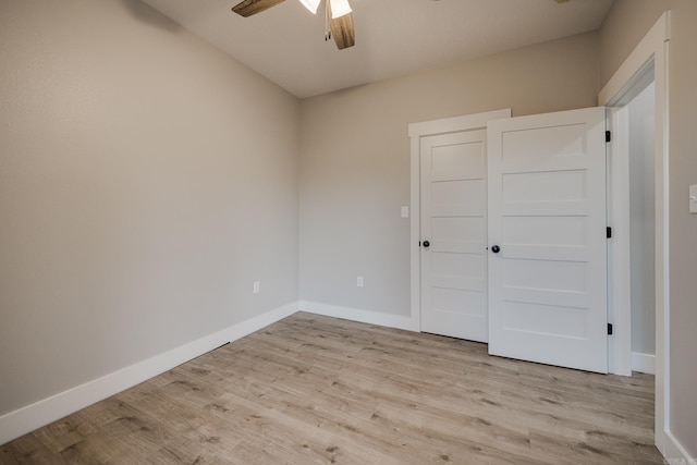 unfurnished bedroom with ceiling fan, a closet, and light hardwood / wood-style flooring