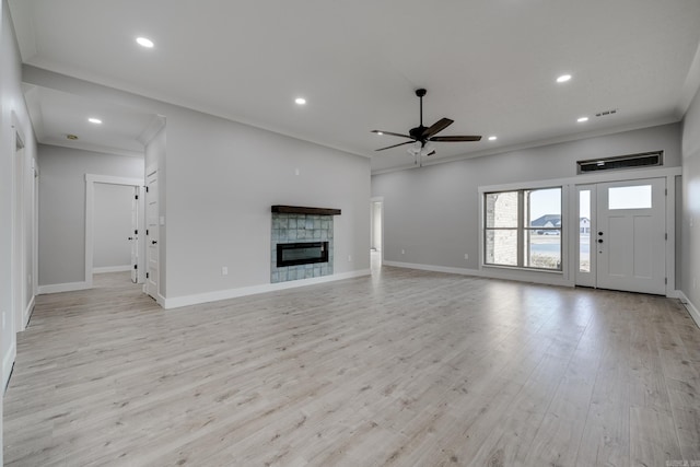 unfurnished living room with crown molding, ceiling fan, and light hardwood / wood-style flooring