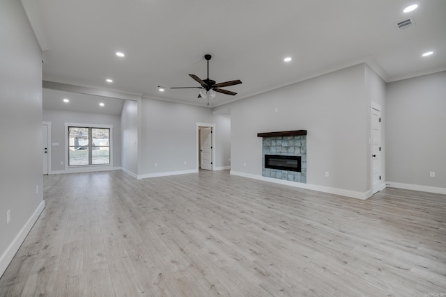 unfurnished living room featuring ceiling fan, ornamental molding, and light hardwood / wood-style flooring