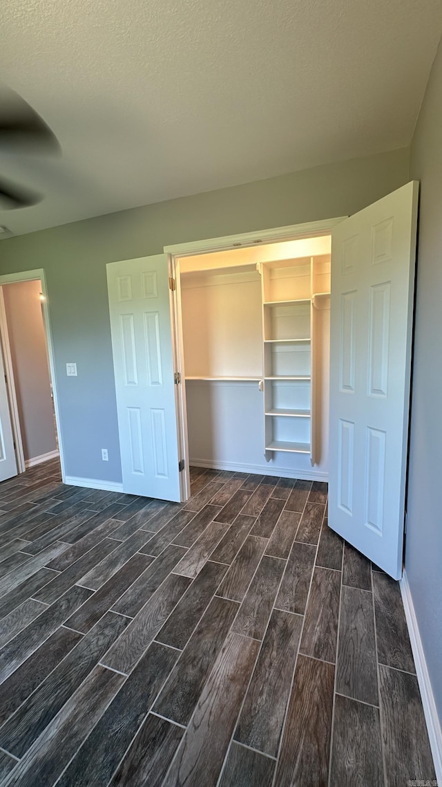 unfurnished bedroom featuring a closet and a textured ceiling