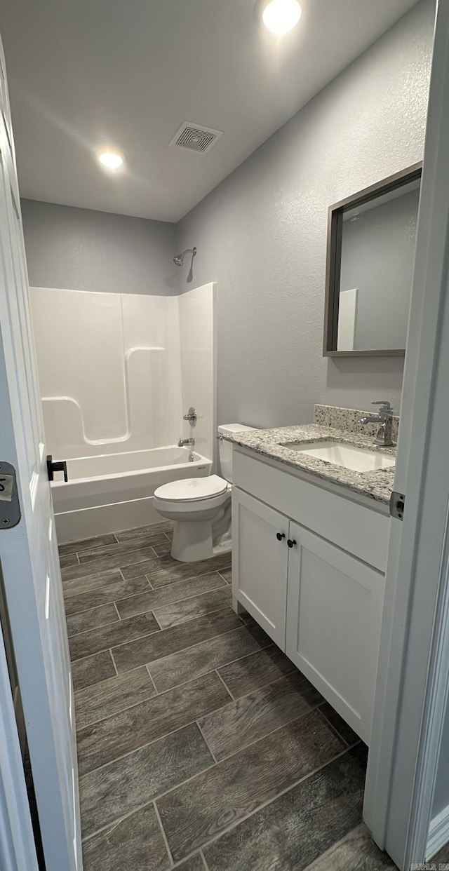 full bathroom featuring shower / bathing tub combination, vanity, and toilet