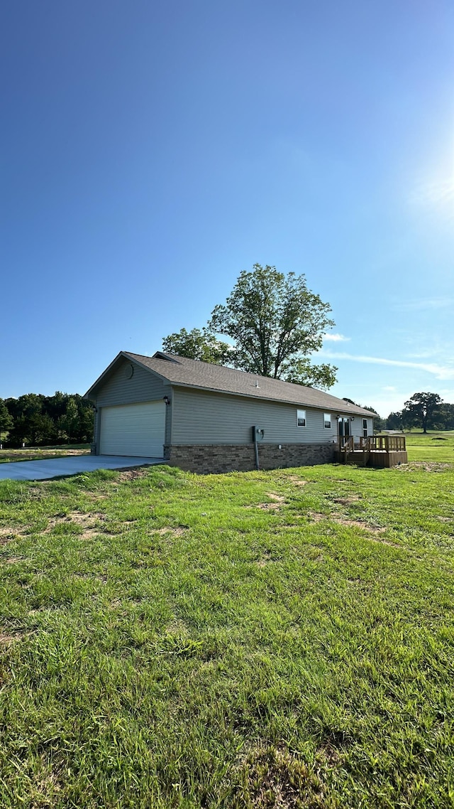 view of side of home with a garage and a yard