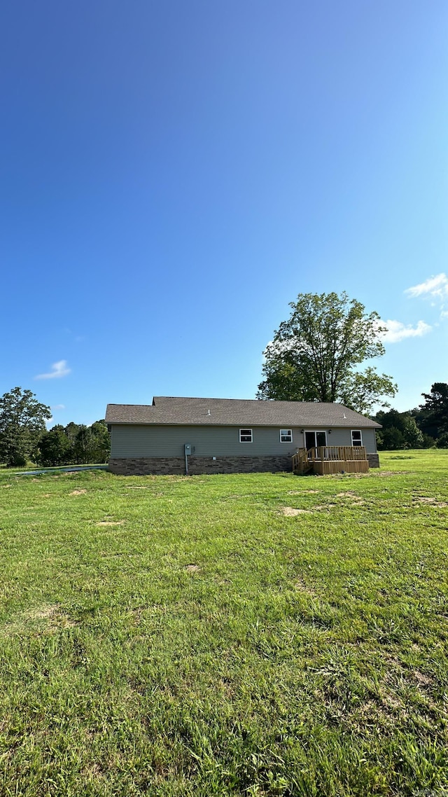 rear view of property with a yard