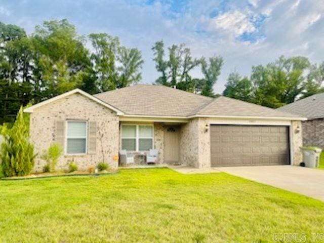 single story home featuring a garage and a front lawn