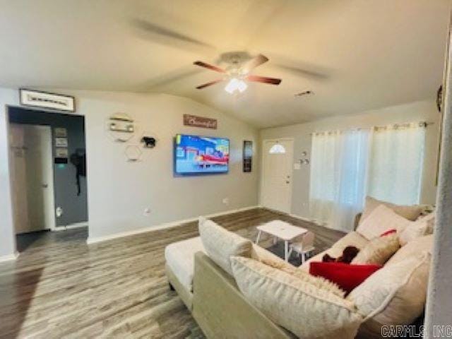 living room featuring hardwood / wood-style flooring, vaulted ceiling, and ceiling fan