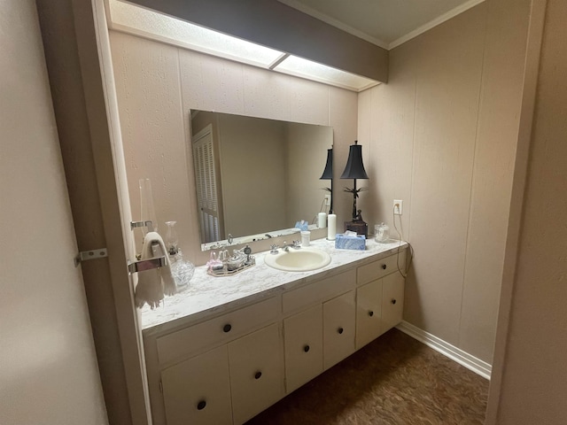 bathroom with vanity, crown molding, and a skylight