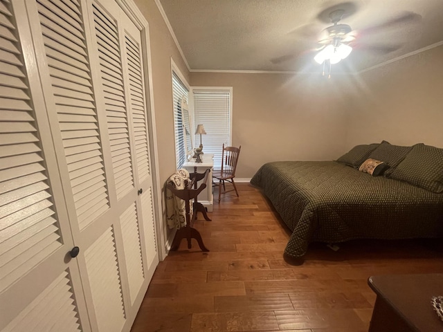 bedroom featuring crown molding, ceiling fan, and dark hardwood / wood-style flooring