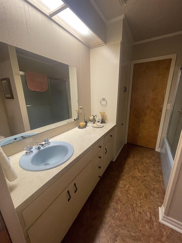 bathroom featuring crown molding and vanity