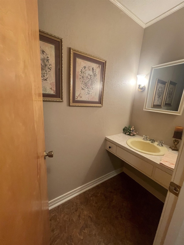 bathroom with crown molding and sink