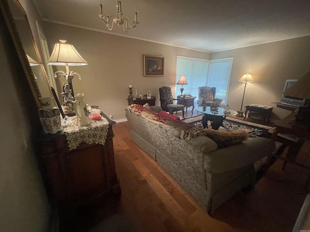 living room with dark hardwood / wood-style flooring, ornamental molding, and an inviting chandelier