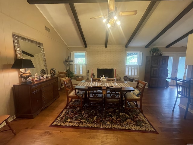 dining space with wood-type flooring, lofted ceiling with beams, french doors, and ceiling fan