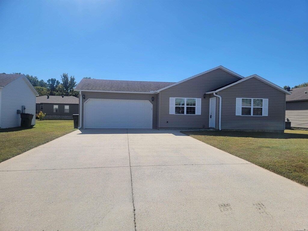 single story home with a front lawn and a garage