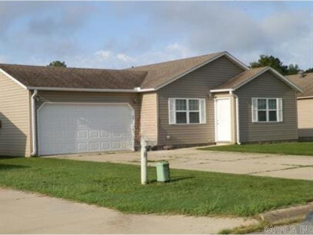 single story home with a front lawn and a garage