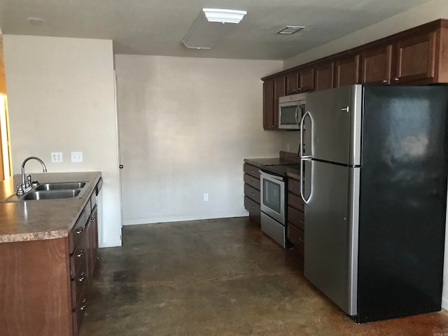 kitchen featuring dark brown cabinets, appliances with stainless steel finishes, and sink