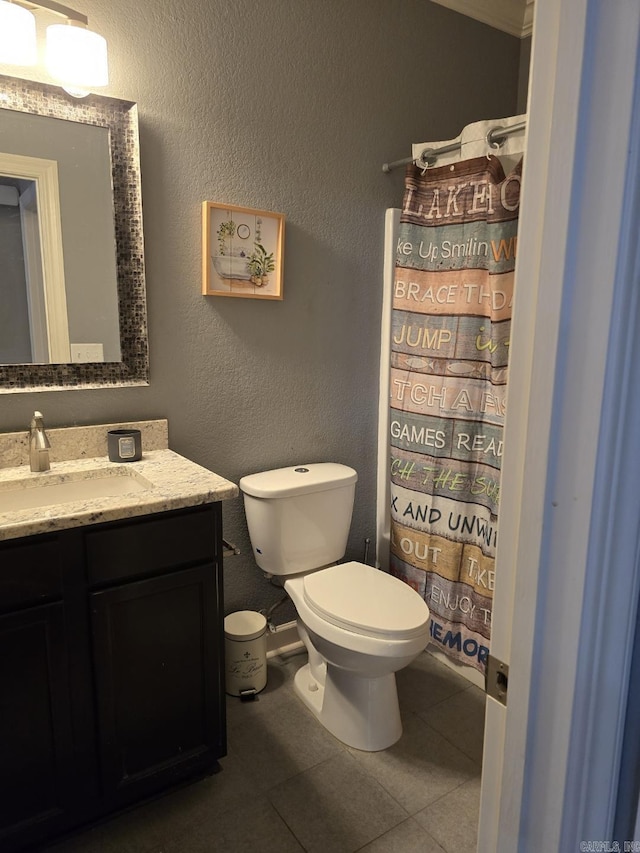 bathroom with vanity, tile patterned floors, and toilet