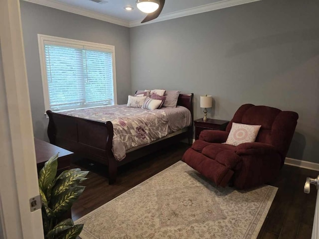 bedroom featuring crown molding, dark hardwood / wood-style floors, and ceiling fan