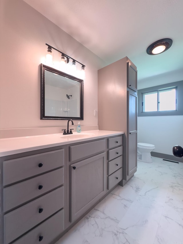 bathroom featuring vanity and toilet