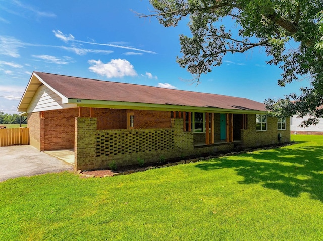 back of property featuring a lawn