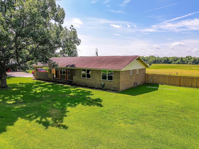 rear view of house featuring a lawn