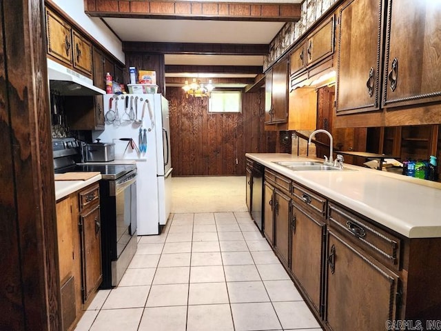 kitchen featuring wood walls, beamed ceiling, dishwasher, sink, and stainless steel range with electric cooktop