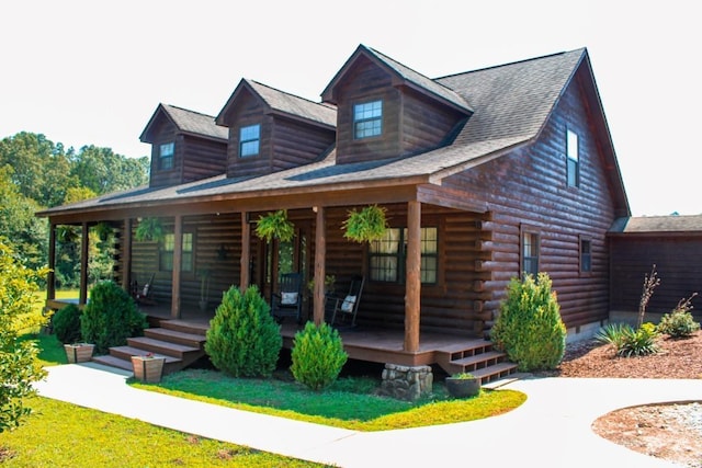 log home featuring covered porch