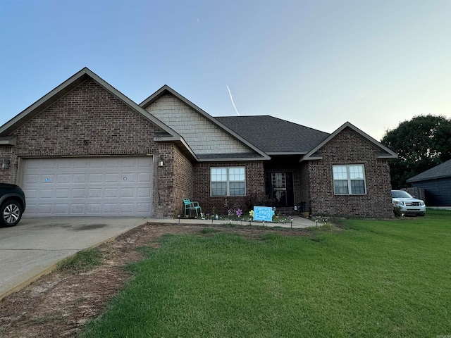 view of front of house with a garage and a front lawn