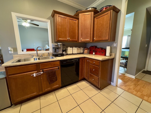 kitchen with light tile patterned floors, a sink, light countertops, dishwasher, and brown cabinetry