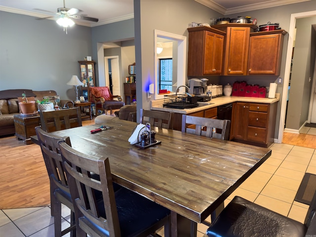 dining room with ornamental molding, ceiling fan, and light tile patterned floors