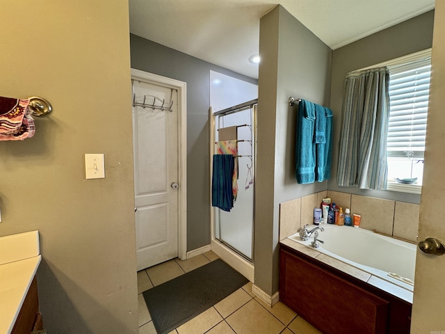 full bath featuring a stall shower, tile patterned flooring, baseboards, and a bath