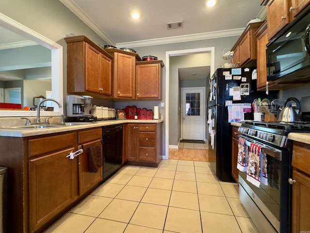 kitchen featuring light tile patterned floors, a sink, visible vents, light countertops, and black appliances