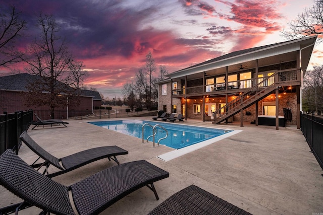 pool at dusk with a patio