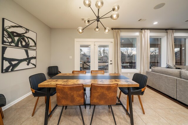 dining area featuring a wealth of natural light, a chandelier, and light tile patterned floors