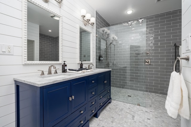 bathroom with vanity and tiled shower